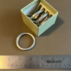 Set of 4 stamped steel (?) napkin rings